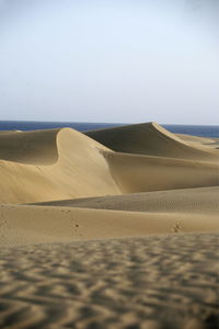 Scenic view of desert against sea