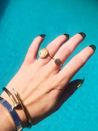 Close-up of woman hand holding swimming pool