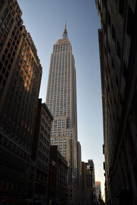 Low angle view of empire state building in city