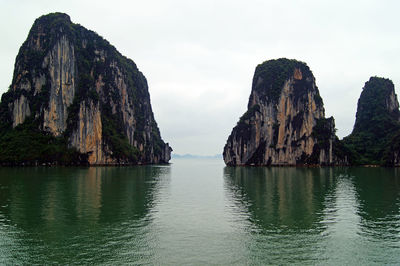 Scenic view of rocks in sea against sky