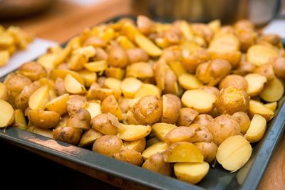 Slices of baked mini potatoes on a metal tray