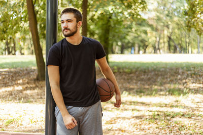 Portrait of beautiful trendy fashionable hispanic teenager male in basketball court