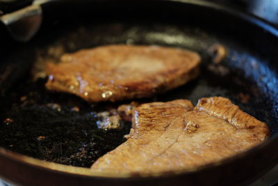 Close-up of meat in cooking pan