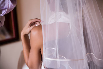 Midsection of bride wearing veil