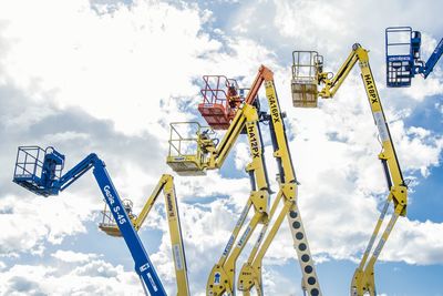 Low angle view of crane against sky