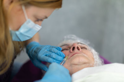 Cropped image of woman applying nail