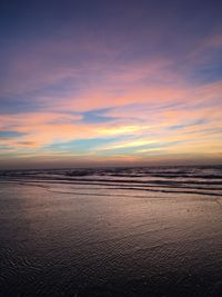 Scenic view of beach against sky during sunset