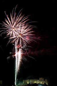 Low angle view of firework display at night