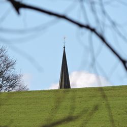 Close-up of cross against sky