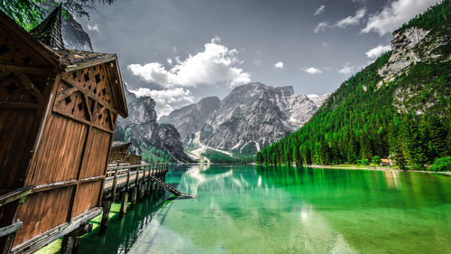 Scenic view of lake pragser wildsee by mountains against sky