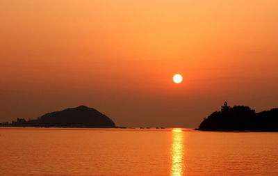 Scenic view of sea against orange sky