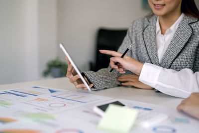 Midsection of businessman working at office