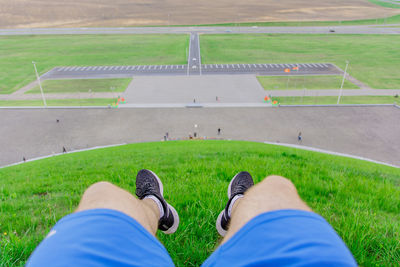 Low section of man standing on field