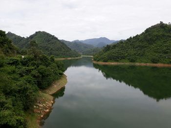 Scenic view of lake and mountains against sky