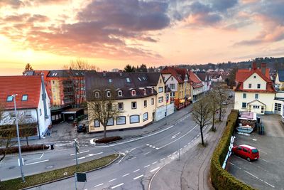 High angle view of city street and buildings against sky