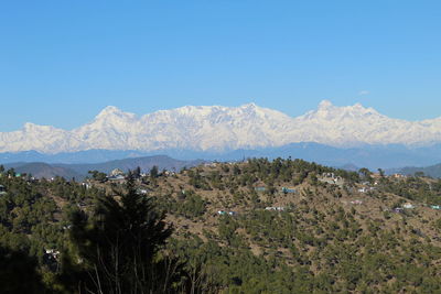 Scenic view of mountains against clear blue sky