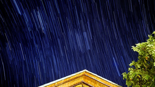 Low angle view of illuminated building against sky at night