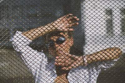 Shadow of fence in cage at zoo