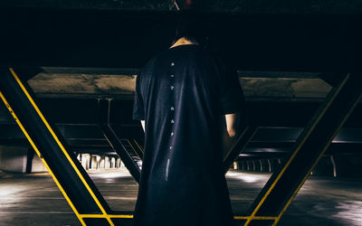 Low section of man standing on staircase