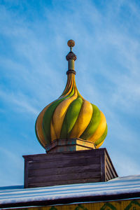 Low angle view of bell tower against blue sky