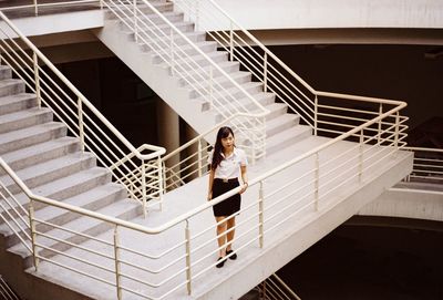 Portrait of woman standing on staircase