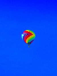Multi colored hot air balloons against blue sky