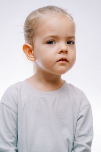 Portrait of young woman against white background