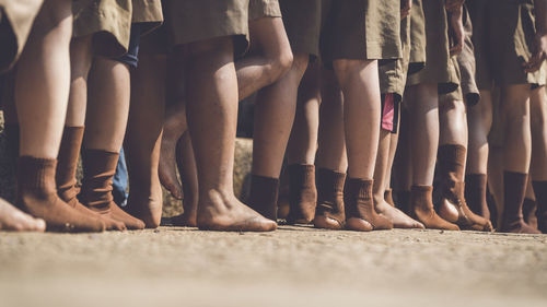 Low section of students standing on footpath