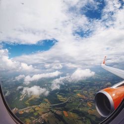 Cropped image of airplane wing over landscape