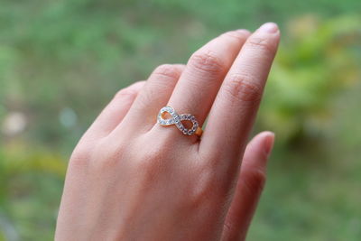 Cropped hand of woman wearing ring outdoors