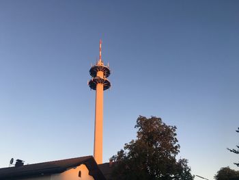 Low angle view of communications tower against clear sky