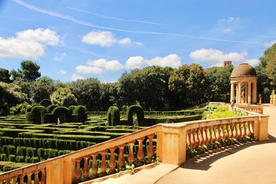 Built structure in garden against cloudy sky