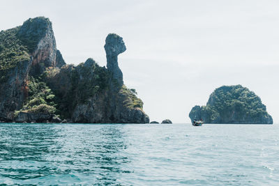 Scenic view of rocks in sea against sky