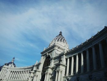 Low angle view of building against cloudy sky