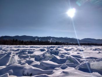 Scenic view of snow covered landscape against sky