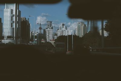 Buildings in city seen through car