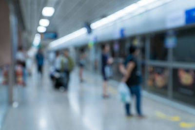 People on illuminated subway station