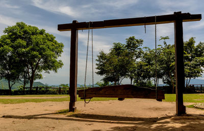 Swing at playground against sky