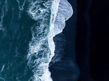 Iceland black sand beach with huge waves at reynisfjara vik.