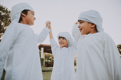 Friends standing on cross