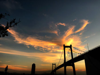 Low angle view of bridge against sky during sunset