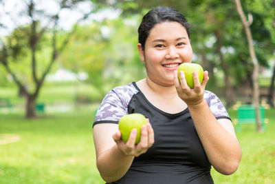 Smiling man holding apple