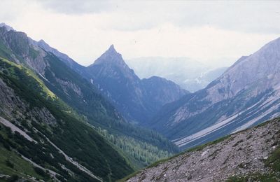 Scenic view of valley and mountains against sky