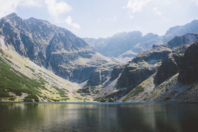 Scenic view of lake and mountains against sky