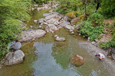 High angle view of stream amidst rocks in river