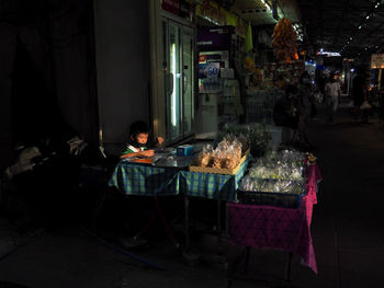 Man sitting on chair in illuminated room