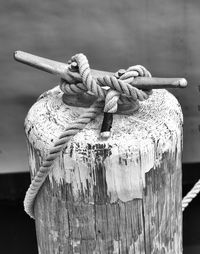 Close-up of rope tied on wooden post