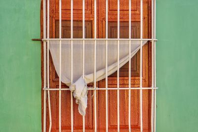 Curtain hanging at wooden window