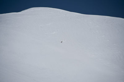 Person snowboarding on snowy mountain