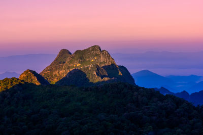 Rock formation against sky during sunset